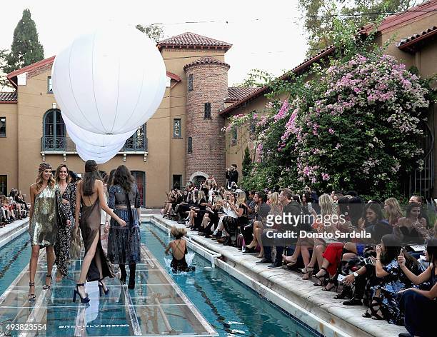 Models walk the runway at the REVOLVE fashion show benefiting Stand Up To Cancer on October 22, 2015 in Los Angeles, California.