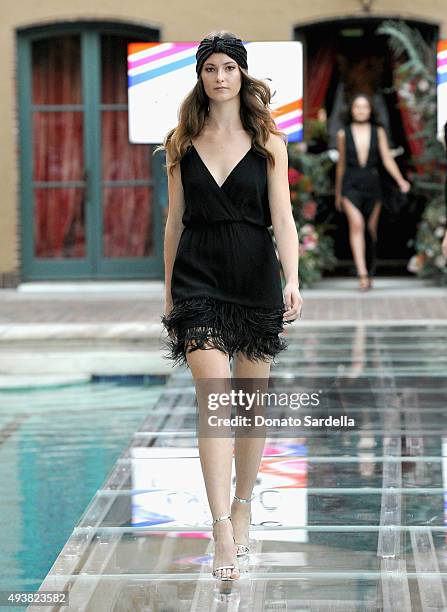 Model walks the runway at the REVOLVE fashion show benefiting Stand Up To Cancer on October 22, 2015 in Los Angeles, California.