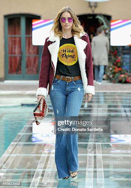 Model walks the runway at the REVOLVE fashion show benefiting Stand Up To Cancer on October 22, 2015 in Los Angeles, California.