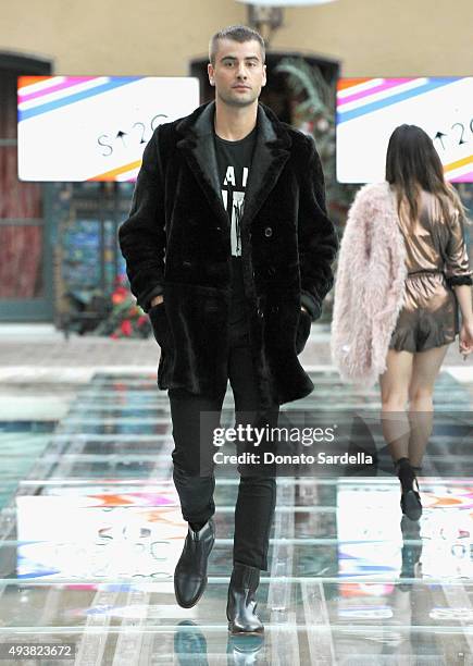 Model walks the runway at the REVOLVE fashion show benefiting Stand Up To Cancer on October 22, 2015 in Los Angeles, California.