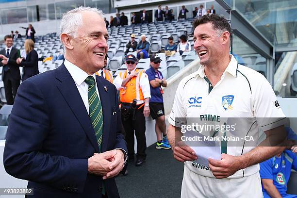 Australian Prime Minister Malcom Turnbull chats with Michael Hussey before the tour match between the Prime Minister's XI and New Zealand at Manuka...