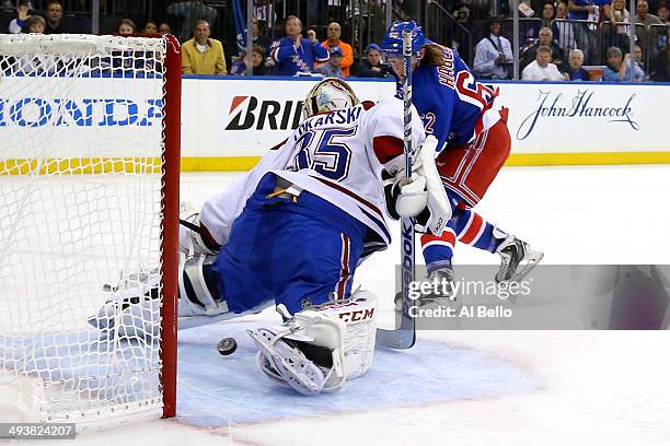 Carl Hagelin of the New York Rangers scores a goal against Dustin Tokarski of the Montreal Canadiens in the first period during Game Four of the...