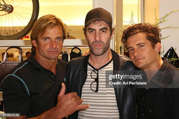 Professional surfer Laird Hamilton, actor Sacha Baron Cohen, and actor Orlando Bloom attend the launch of Laird Apparel by Laird Hamilton at Ron...