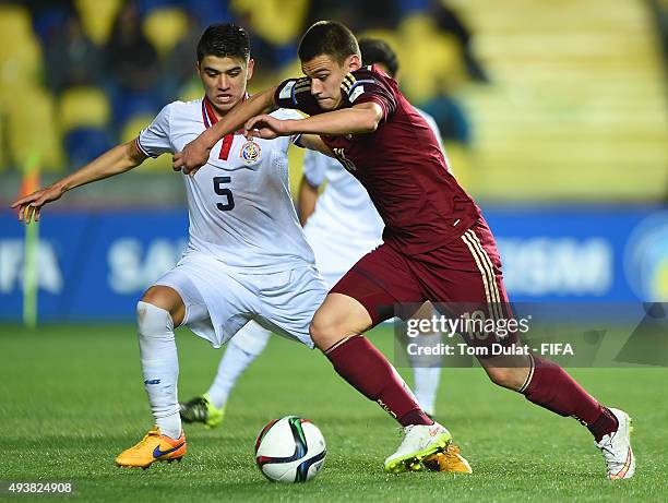 Egor Denisov of Russia and Esteban Gonzalez Rivera of Costa Rica battle for the ball during the FIFA U-17 World Cup Chile 2015 Group E match between...