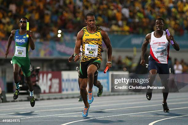 Yohan Blake of Jamaica of crosses the finish line ahead of Dwain Chambers of Great Britain to win the Men's 4x100 metres relay final during day two...