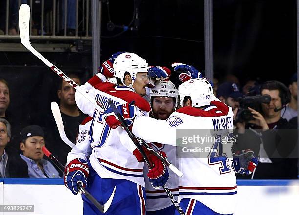 Francis Bouillon of the Montreal Canadiens celebrates with his teammates Rene Bourque, David Desharnais and Mike Weaver after scoring a goal in the...