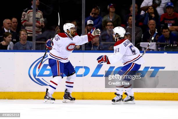 Francis Bouillon of the Montreal Canadiens celebrates with his teammate David Desharnais after scoring a goal in the second period against Henrik...