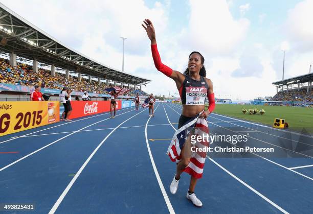 Sanya Richards-Ross of the United States waves to fans as she rounds the track after winning the Women's 4x400 metres relay final during day two of...
