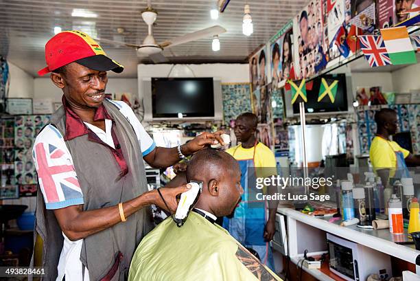 barber at work in west africa - barber flag stock pictures, royalty-free photos & images
