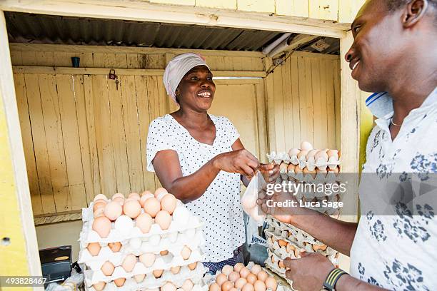 sole trader serving from her egg shop - ghana woman stock pictures, royalty-free photos & images