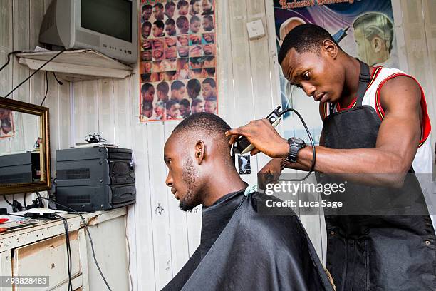 barber at work in west africa - barber holding scissors stock pictures, royalty-free photos & images
