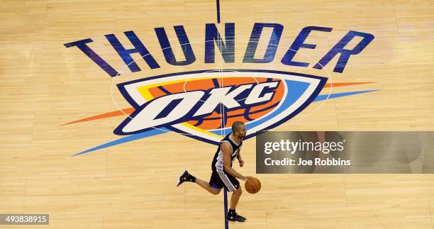 Tony Parker of the San Antonio Spurs brings the ball up court in the first half against the Oklahoma City Thunder during Game Three of the Western...