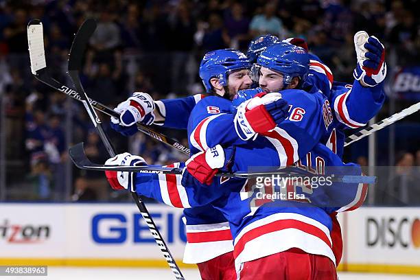 Derick Brassard of the New York Rangers celebrates with his teammates after scoring a goal late in th second period against Dustin Tokarski of the...