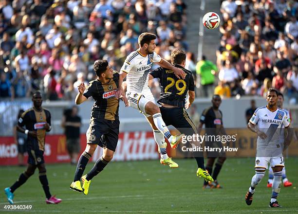 Tommy Meyer of Los Angeles Galaxy heads the ball between Leo Fernandes and Antoine Hoppenot of Philadelphia Union during the first half at StubHub...