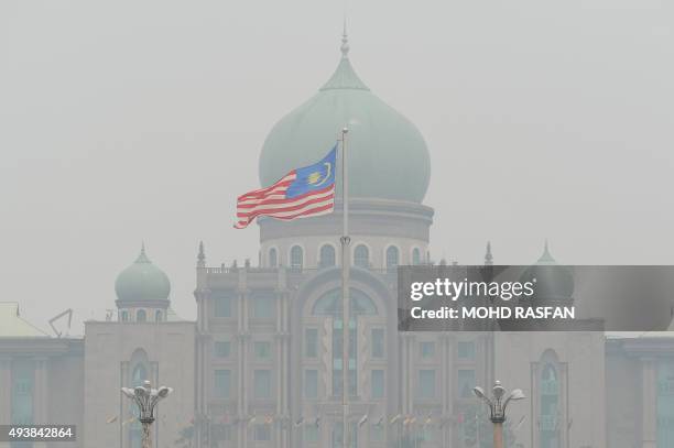 Malaysian flag flutters in front of the prime minister's office in Putrajaya on October 23, 2015. Fires raging across huge areas of Indonesia are...