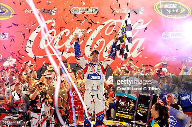 Jimmie Johnson, driver of the Lowe's Patriotic Chevrolet, celebrates in victory lane after winning the NASCAR Sprint Cup Series Coca-Cola 600 at...