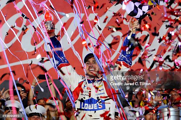 Jimmie Johnson, driver of the Lowe's Patriotic Chevrolet, celebrates in victory lane after winning the NASCAR Sprint Cup Series Coca-Cola 600 at...