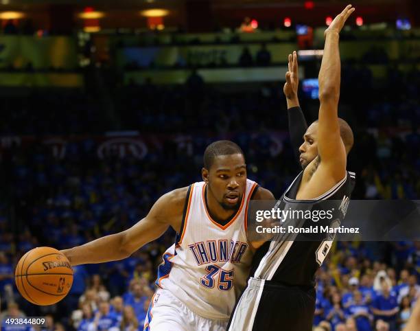 Kevin Durant of the Oklahoma City Thunder handles the ball against Patty Mills of the San Antonio Spurs in the second half during Game Three of the...