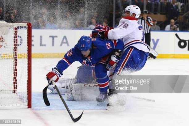 Miller of the New York Rangers gets checked into the goal post by Andrei Markov of the Montreal Canadiens in the second period during Game Four of...
