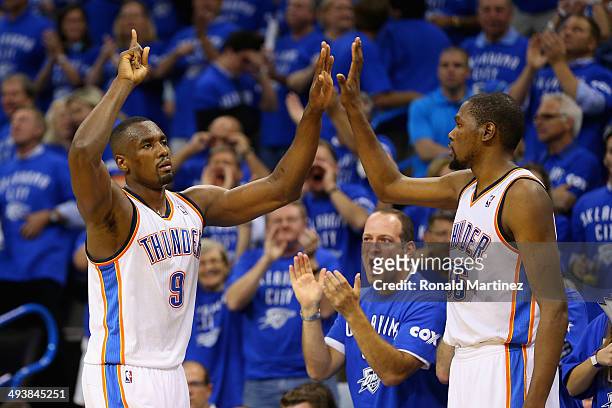 Serge Ibaka and Kevin Durant of the Oklahoma City Thunder celebrate late in the second half against the San Antonio Spurs during Game Three of the...