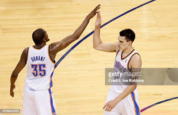 Kevin Durant and Steven Adams of the Oklahoma City Thunder celebrate after a play in the second half against the San Antonio Spurs during Game Three...