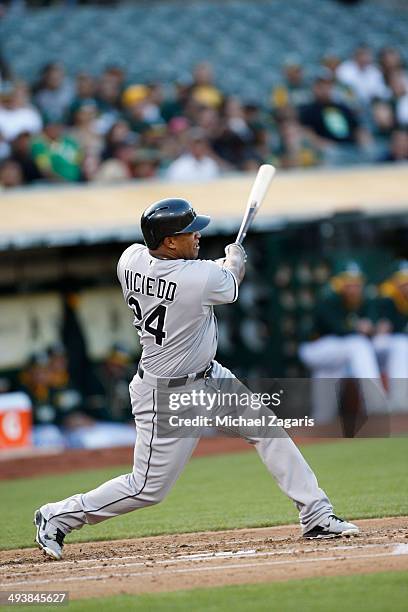 Dayan Viciedo of the Chicago White Sox hits a home run during the game against the Oakland Athletics at O.co Coliseum on May 12, 2014 in Oakland,...