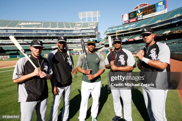 Yoenis Cespedes of the Oakland Athletics stands with other Cuban immigrants Adrian Nieto, Alexei Ramirez, Dayan Viciedo and Jose Abreu of the Chicago...