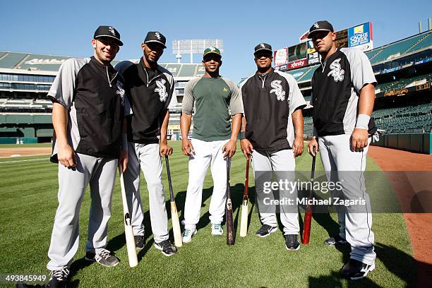 Yoenis Cespedes of the Oakland Athletics stands with other Cuban immigrants Adrian Nieto, Alexei Ramirez, Dayan Viciedo and Jose Abreu of the Chicago...