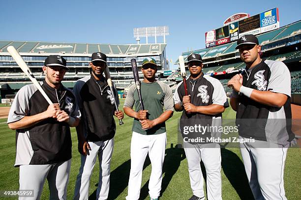 Yoenis Cespedes of the Oakland Athletics stands with other Cuban immigrants Adrian Nieto, Alexei Ramirez, Dayan Viciedo and Jose Abreu of the Chicago...