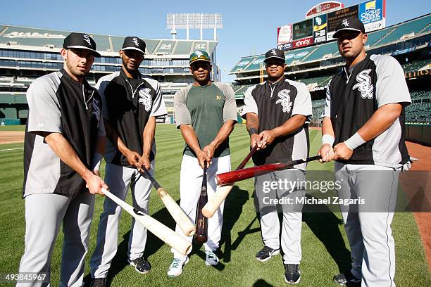 Yoenis Cespedes of the Oakland Athletics stands with other Cuban immigrants Adrian Nieto, Alexei Ramirez, Dayan Viciedo and Jose Abreu of the Chicago...