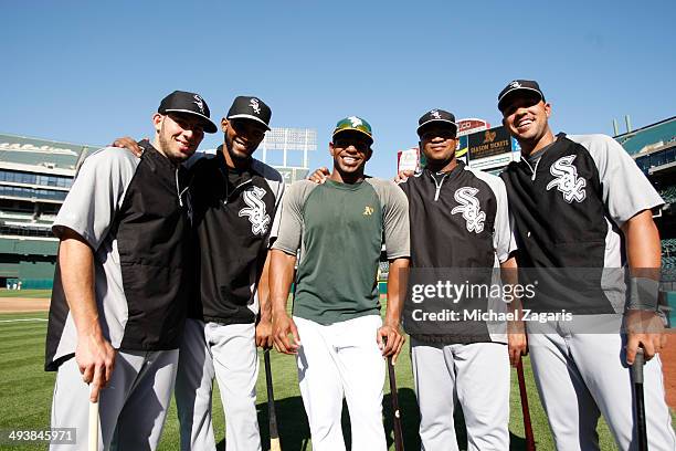 Yoenis Cespedes of the Oakland Athletics stands with other Cuban immigrants Adrian Nieto, Alexei Ramirez, Dayan Viciedo and Jose Abreu of the Chicago...