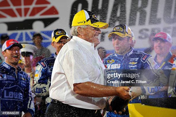 Team owner Rick Hendrick celebrates in victory lane after Jimmie Johnson, driver of the Lowe's Patriotic Chevrolet, wins the NASCAR Sprint Cup Series...