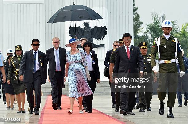 Danish Queen Margrethe II is accompanied by Indonesian officials during her visit to the Kalibata Hero Graveyard in Jakarta, Indonesia, on October...