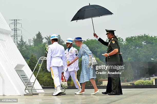 Danish Queen Margrethe II lays wreath, accompanied by Indonesian officials, during her visit at Kalibata Hero Graveyard in Jakarta, Indonesia, on...