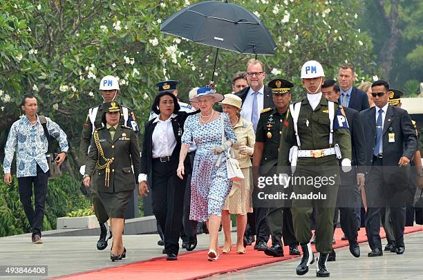 Danish Queen Margrethe II is accompanied by Indonesian officials during her visit to the Kalibata Hero Graveyard in Jakarta, Indonesia, on October...