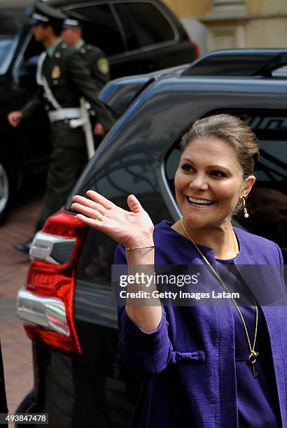 Crown Princess Victoria of Sweden waves as she walks down a street of downtown Bogota after holding a private meeting with Colombia's president Juan...