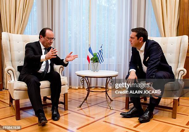 Greek prime minister Alexis Tsipras talks with French President Francois Hollande during their meeting at the Villa Maximos in Athens on October 23,...