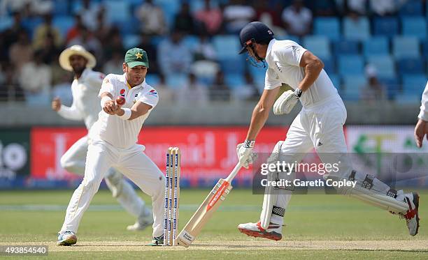 England captain Alastair Cook makes his ground as Yasir Shah of Pakistan fumbles a run out attempt during day two of the 2nd test match between...