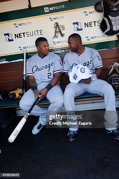 Dayan Viciedo and Alejandro De Aza of the Chicago White Sox relax in the dugout prior to the game against the Oakland Athletics at O.co Coliseum on...
