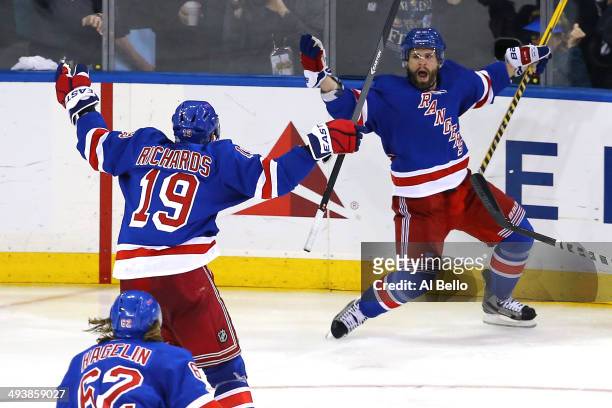 Martin St. Louis of the New York Rangers celebrates with teammates Brad Richards after scoring the game winning shot in overtime against Dustin...