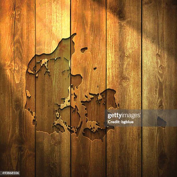 denmark map on lit wooden background - nordic interior stock illustrations