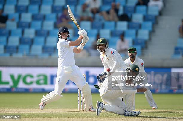 Joe Root of England hits past Shan Masood of Pakistan during day two of the 2nd test match between Pakistan and England at Dubai Cricket Stadium on...