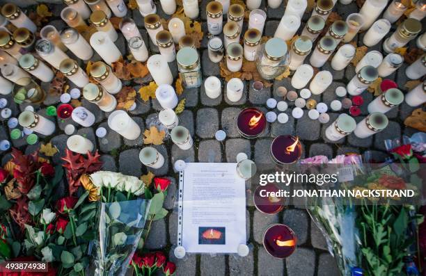 Flowers and candles have been set outside the primary and middle school Kronan in Trollhattan, southwestern Sweden, on October 23 where a masked man...