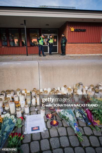 Flowers and candles have been set outside the primary and middle school Kronan in Trollhattan, southwestern Sweden, on October 23 where a masked man...