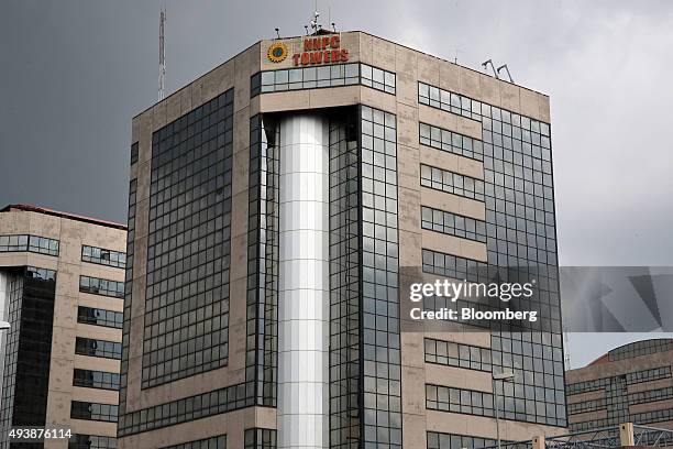 The head offices of the Nigerian National Petroleum Corp. Stand in Abuja, Nigeria, on Wednesday, Oct. 21, 2015. A drop in crude prices in the past...