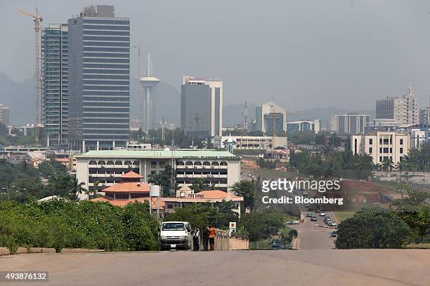 Commercial towers sit on the city skyline beyond a highway in Abuja, Nigeria, on Wednesday, Oct. 21, 2015. A drop in crude prices in the past year...