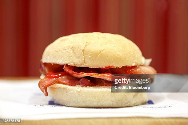Bacon roll sits on a customer's table in a Greggs Plc sandwich chain outlet in Caterham, U.K., on Thursday, Oct. 22, 2015. Same-store sales at Greggs...