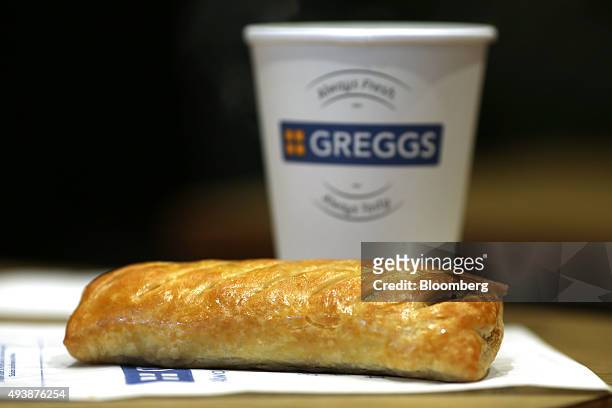 Sausage roll and a cup of tea sit on a customer's table in a Greggs Plc sandwich chain outlet in Caterham, U.K., on Thursday, Oct. 22, 2015....