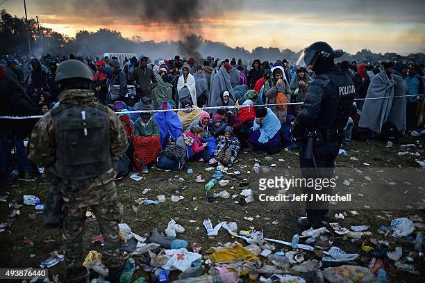 Migrants are held back by the police near the village of Rigonce,before being walked to Brezice refugee camp on October 23, 2015 in Rigonce,...