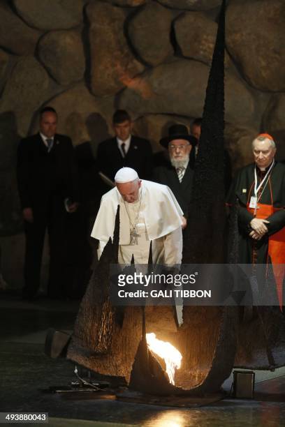 Pope Francis rekindles the eternal flame at the Hall of Remembrance on May 26 during his visit to the Yad Vashem Holocaust Memorial museum in...
